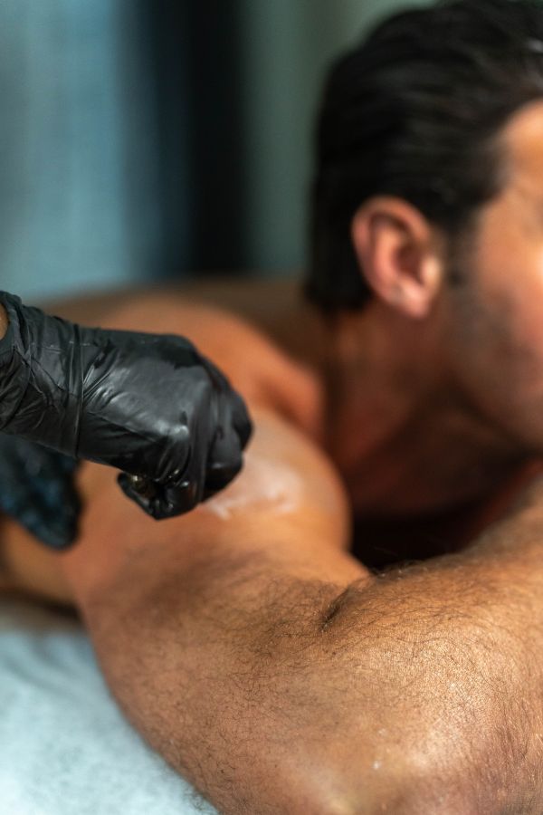 Closeup of male receiving wax treatment